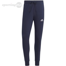 Spodnie męskie adidas Essentials French Terry Tapered Cuff 3-Stripes granatowe IC9406 Adidas